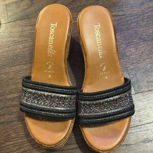 Women’s size 8 Toscanella Made in Italy Wedge Sandals with black and gold band.